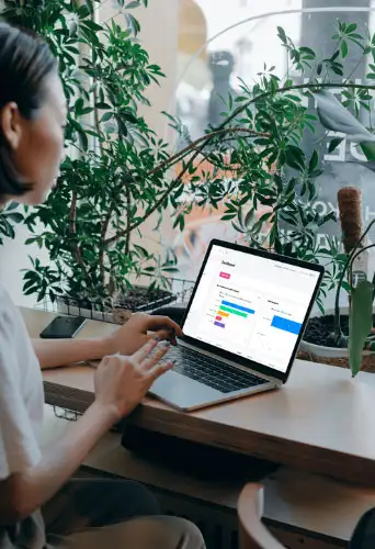 Professional working on laptop viewing Xono partner page for employee engagement